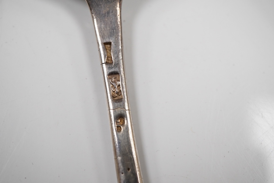 A pair of George III silver gilt Old English pattern berry spoons, London, 1787, 21.8cm, two other earlier silver berry spoons and an Edwardian serving spoon by William Hutton & Sons, London, 1901, 9oz.